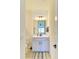 Well-lit bathroom features a gray vanity, tile flooring, and a decorative rug to add style to the space at 13071 Willow Grove Dr, Riverview, FL 33579