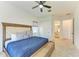 Spacious bedroom features soft carpet, ceiling fan, closet and a bed with a blue comforter, creating a relaxing retreat at 13071 Willow Grove Dr, Riverview, FL 33579