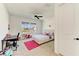 A bedroom with a desk, bed, and a view of the outside at 13071 Willow Grove Dr, Riverview, FL 33579