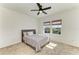 A bedroom with a bed, ceiling fan, and a view of the outside at 13071 Willow Grove Dr, Riverview, FL 33579