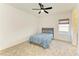 Cozy bedroom with plush carpet, a comfortable bed, and natural light from a window at 13071 Willow Grove Dr, Riverview, FL 33579