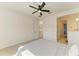 A bedroom with a ceiling fan, bed, and a view of the hallway and bathroom at 13071 Willow Grove Dr, Riverview, FL 33579
