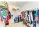 Spacious walk-in closet with extensive shelving and hanging storage for clothes and accessories at 13071 Willow Grove Dr, Riverview, FL 33579
