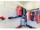 Well-organized walk-in closet with ample shelving and hanging space for clothes and shoes at 13071 Willow Grove Dr, Riverview, FL 33579