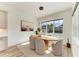 Dining area with modern light fixture, large windows, and views of the lush backyard at 13071 Willow Grove Dr, Riverview, FL 33579