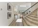 Inviting entryway with carpeted stairs, modern art, and an open view to the living area at 13071 Willow Grove Dr, Riverview, FL 33579