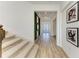 Bright entryway with modern decor, staircase, wood floors, and round mirror on an accent wall at 13071 Willow Grove Dr, Riverview, FL 33579