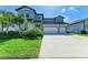 Well-manicured lawn and three car garage highlight this home's exterior at 13071 Willow Grove Dr, Riverview, FL 33579