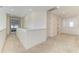 Upstairs hallway featuring neutral carpet, white walls and a view to a seating area at 13071 Willow Grove Dr, Riverview, FL 33579