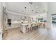 Modern kitchen with stainless steel appliances, quartz countertops, and an island with seating for four at 13071 Willow Grove Dr, Riverview, FL 33579