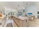 Kitchen island with a breakfast bar, modern lighting, and views of the dining and living areas at 13071 Willow Grove Dr, Riverview, FL 33579