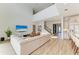 Open-concept living area with high ceilings, comfortable seating, and a view of the modern kitchen at 13071 Willow Grove Dr, Riverview, FL 33579