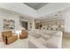 Bright, open living room features a large sectional, modern decor, and staircase to second floor at 13071 Willow Grove Dr, Riverview, FL 33579