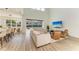 Bright, open-concept living space with modern furniture and sliding glass doors to the backyard at 13071 Willow Grove Dr, Riverview, FL 33579