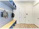 Organized mudroom featuring hooks, shelves, and a bench, providing a practical and stylish entryway solution at 13071 Willow Grove Dr, Riverview, FL 33579