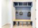 Inviting mudroom with bench, storage, and stylish wood paneled accent wall at 13071 Willow Grove Dr, Riverview, FL 33579