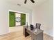 Bright office with desk, chair, modern decor, and wood flooring for a comfortable and productive workspace at 13071 Willow Grove Dr, Riverview, FL 33579