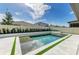 Modern pool area features tile surround and manicured landscaping at 13071 Willow Grove Dr, Riverview, FL 33579