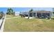 Landscaped backyard featuring a screened-in patio with grilling area, near the waterfront at 13401 Neptune Dr, Hudson, FL 34667