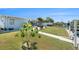 Lush backyard featuring a patio, waterfront access and landscaping at 13401 Neptune Dr, Hudson, FL 34667