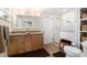 Bright bathroom featuring a double sink vanity, glass shower, and wood-look tile floors at 13401 Neptune Dr, Hudson, FL 34667