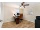 Bedroom/Office space with wood-look tile flooring, a ceiling fan, and bright natural light at 13401 Neptune Dr, Hudson, FL 34667