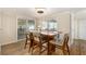 Elegant dining room with stylish table, chairs, and natural light from sliding glass doors at 13401 Neptune Dr, Hudson, FL 34667