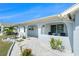 Charming home with covered porch, manicured landscaping, and elegant architectural details at 13401 Neptune Dr, Hudson, FL 34667