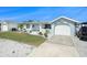 Charming single-story home with a well-manicured lawn and attached garage at 13401 Neptune Dr, Hudson, FL 34667