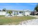 Charming single-story home featuring a well-maintained lawn, mature landscaping, and attached garage at 13401 Neptune Dr, Hudson, FL 34667