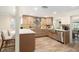 Open kitchen featuring a large quartz island, stainless steel appliances, and wood-look tile flooring at 13401 Neptune Dr, Hudson, FL 34667