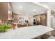 Bright kitchen boasts stainless steel appliances, mosaic tile backsplash, and a spacious quartz breakfast bar at 13401 Neptune Dr, Hudson, FL 34667