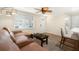 Comfortable living room featuring a plush sofa, stylish coffee table, and modern ceiling fan at 13401 Neptune Dr, Hudson, FL 34667