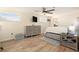 Well-lit bedroom with wood-look tile flooring and access to the ensuite bathroom at 13401 Neptune Dr, Hudson, FL 34667