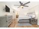 Spacious bedroom with wood-look tile flooring, and ensuite bathroom at 13401 Neptune Dr, Hudson, FL 34667