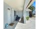 Inviting covered porch with seating area, creating a cozy and welcoming entrance at 13401 Neptune Dr, Hudson, FL 34667