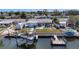 A charming single-story home with a screened lanai and waterfront backyard featuring a boat lift and dock at 13401 Neptune Dr, Hudson, FL 34667