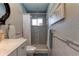 Cozy bathroom featuring tiled walls, a framed mirror, and a shower with a white shower curtain at 1430 Normandy Park Oaks Dr # 9, Clearwater, FL 33756
