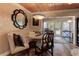 Cozy dining area with a cushioned bench, round table, elegant chairs, and view to the outside patio at 1430 Normandy Park Oaks Dr # 9, Clearwater, FL 33756