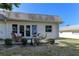 Back patio with comfortable wicker furniture, perfect for outdoor relaxation and entertaining at 1430 Normandy Park Oaks Dr # 9, Clearwater, FL 33756