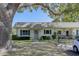 Charming home featuring green shutters, a well-manicured lawn, and a lovely wreath on the front door at 1430 Normandy Park Oaks Dr # 9, Clearwater, FL 33756