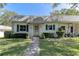 Charming home featuring green shutters and a well-manicured lawn at 1430 Normandy Park Oaks Dr # 9, Clearwater, FL 33756