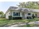 Charming home featuring green shutters and well-maintained landscaping at 1430 Normandy Park Oaks Dr # 9, Clearwater, FL 33756