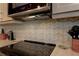 Modern kitchen with stainless steel appliances, custom backsplash, and range hood at 1430 Normandy Park Oaks Dr # 9, Clearwater, FL 33756