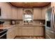 Bright kitchen with white cabinets, chevron backsplash, stainless steel appliances, and wood-look floors at 1430 Normandy Park Oaks Dr # 9, Clearwater, FL 33756