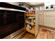 Modern kitchen with pull-out spice rack, stainless steel oven and plenty of storage at 1430 Normandy Park Oaks Dr # 9, Clearwater, FL 33756