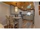 Stylish kitchen with modern appliances, gray cabinets, stone countertops, and wood plank ceiling at 1430 Normandy Park Oaks Dr # 9, Clearwater, FL 33756