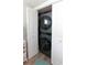Convenient in-closet laundry area features a stacked washer and dryer at 1430 Normandy Park Oaks Dr # 9, Clearwater, FL 33756