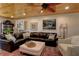 Comfortable living room with a plush leather sectional, patterned rug, and decorative artwork on the walls at 1430 Normandy Park Oaks Dr # 9, Clearwater, FL 33756