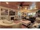 Inviting living room featuring a fireplace, wood ceiling, ceiling fan, and comfortable seating arrangement at 1430 Normandy Park Oaks Dr # 9, Clearwater, FL 33756